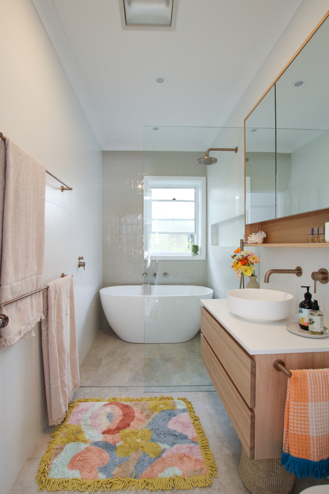 Photo of a contemporary master bathroom in Sydney with flat-panel cabinets, medium wood cabinets, a freestanding tub, a curbless shower, beige tile, a vessel sink, beige floor, an open shower, white benchtops, a niche, a single vanity and a floating vanity.