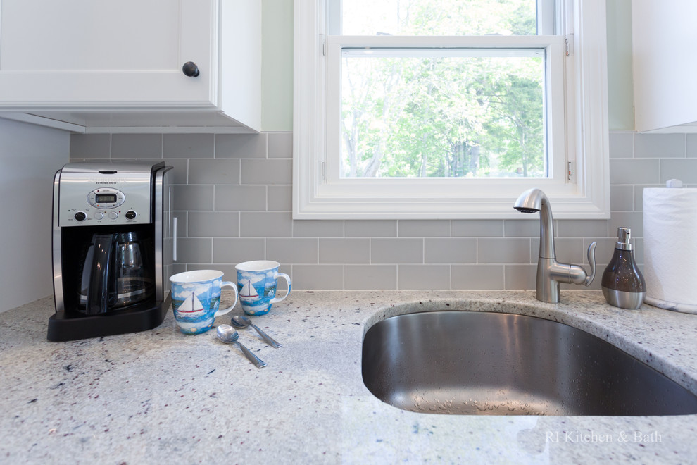 Example of a large transitional l-shaped porcelain tile eat-in kitchen design in Providence with an undermount sink, recessed-panel cabinets, white cabinets, granite countertops, gray backsplash, ceramic backsplash, stainless steel appliances, green walls and an island
