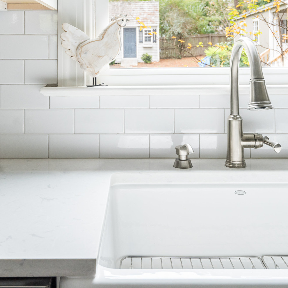 Inspiration for a transitional kitchen in Richmond with a farmhouse sink, shaker cabinets, white cabinets, quartzite benchtops, white splashback, subway tile splashback, stainless steel appliances, dark hardwood floors and with island.