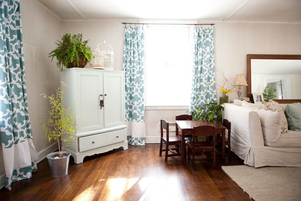 This is an example of a traditional living room in Boston with white walls and dark hardwood floors.