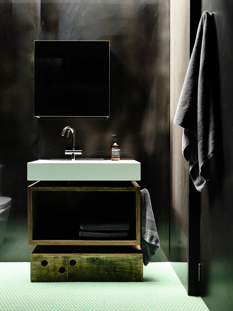 This is an example of a mid-sized contemporary kids bathroom in Melbourne with open cabinets, black cabinets, a freestanding tub, an open shower, a wall-mount toilet, black tile, black walls, a wall-mount sink, wood benchtops and mosaic tile floors.
