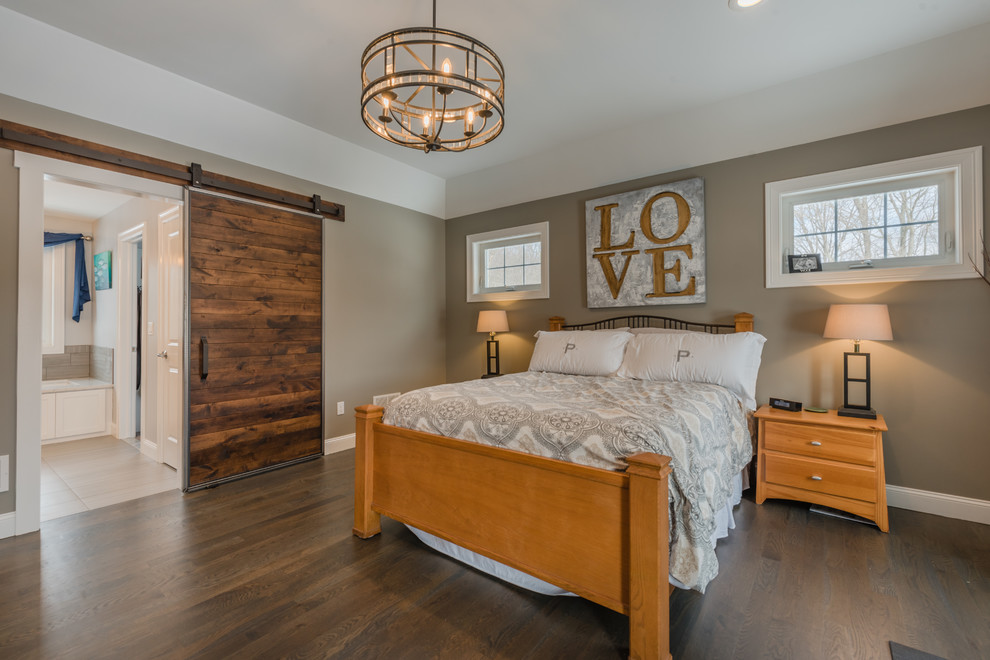 Design ideas for a mid-sized transitional master bedroom in New York with beige walls, dark hardwood floors, no fireplace and brown floor.