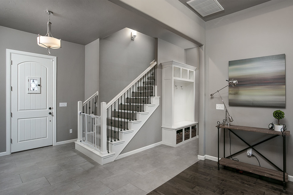 Inspiration for a mid-sized transitional foyer in Oklahoma City with grey walls, porcelain floors, a single front door and a white front door.