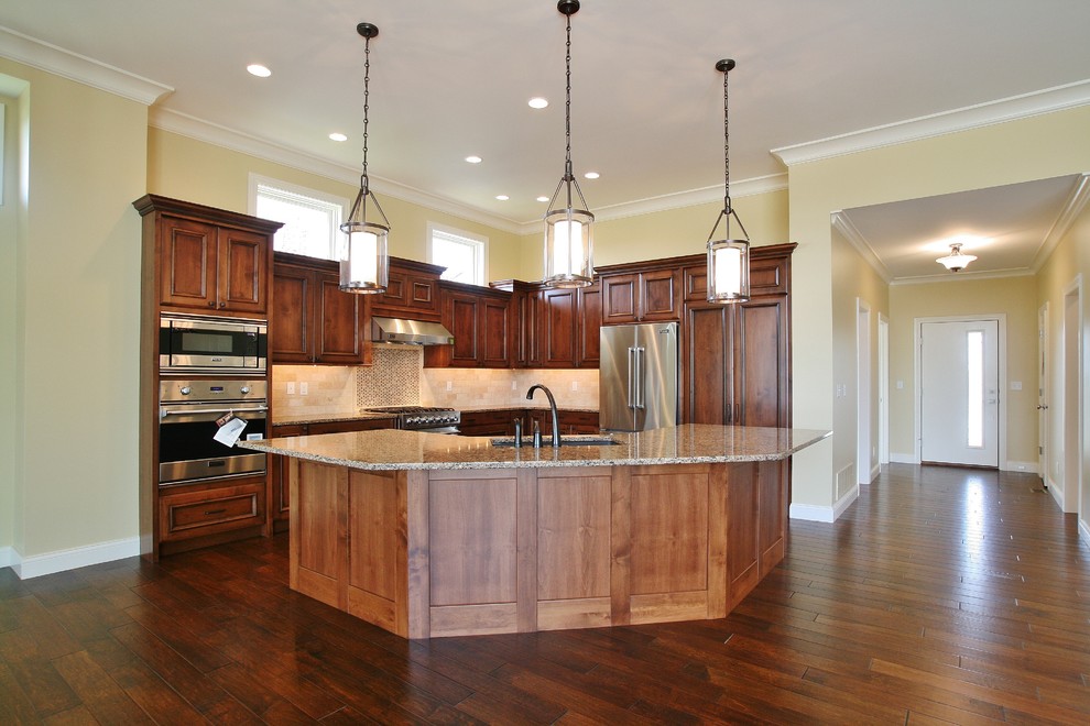 Inspiration for a large transitional l-shaped dark wood floor and brown floor kitchen remodel in Chicago with an undermount sink, recessed-panel cabinets, medium tone wood cabinets, granite countertops, beige backsplash, ceramic backsplash, stainless steel appliances, an island and multicolored countertops