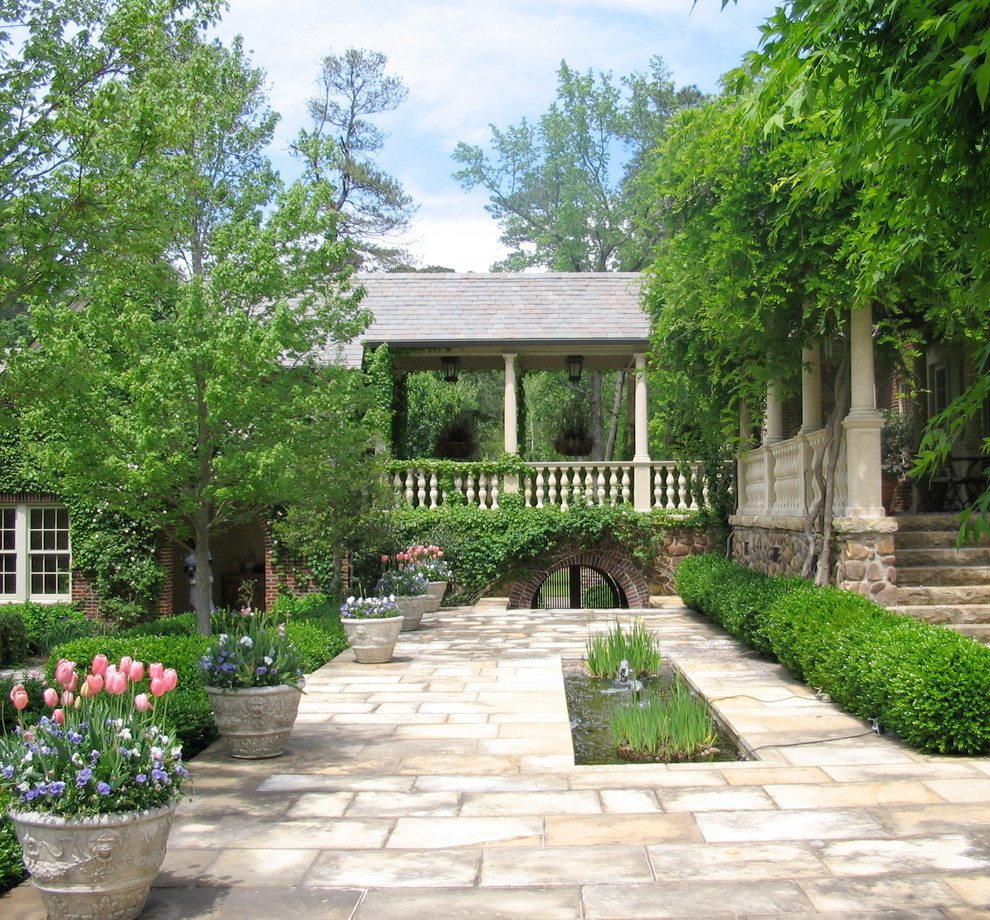 Traditional courtyard garden in Little Rock with a water feature.