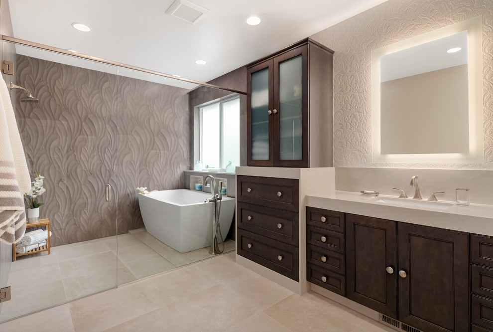 Mid-sized transitional master wet room bathroom in Seattle with dark wood cabinets, a freestanding tub, gray tile, porcelain tile, porcelain floors, an undermount sink, quartzite benchtops, a hinged shower door, recessed-panel cabinets, beige floor and beige benchtops.
