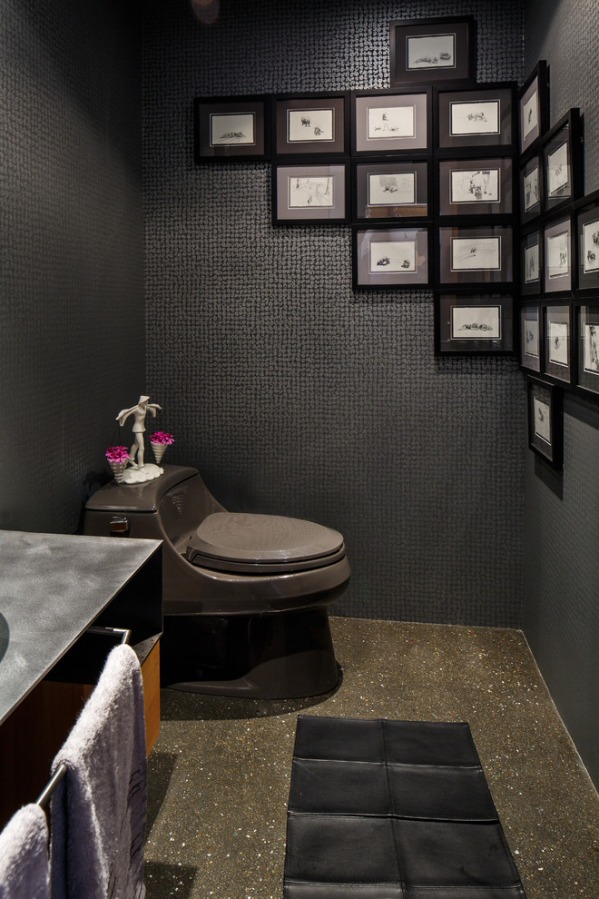 Photo of a mid-sized asian powder room in San Francisco with stainless steel benchtops, black walls, concrete floors, a two-piece toilet and gray tile.