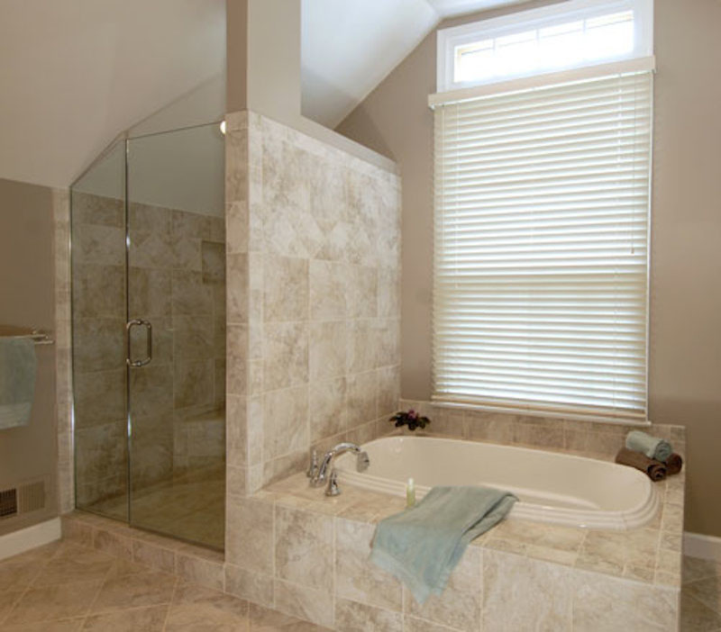 Design ideas for a large contemporary master bathroom in DC Metro with beaded inset cabinets, dark wood cabinets, a drop-in tub, a corner shower, stone tile, beige walls, travertine floors and an undermount sink.
