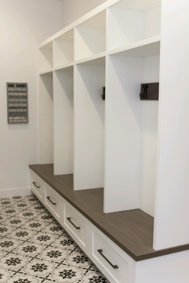 Photo of a mid-sized modern mudroom in Phoenix with white walls, porcelain floors and grey floor.
