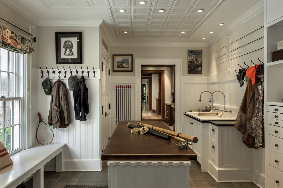 Traditional mudroom in New York with concrete floors.