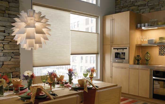 This is an example of a mid-sized contemporary single-wall eat-in kitchen in Phoenix with an undermount sink, flat-panel cabinets, beige cabinets, stainless steel benchtops, beige splashback, timber splashback, stainless steel appliances, light hardwood floors, no island, beige floor and grey benchtop.