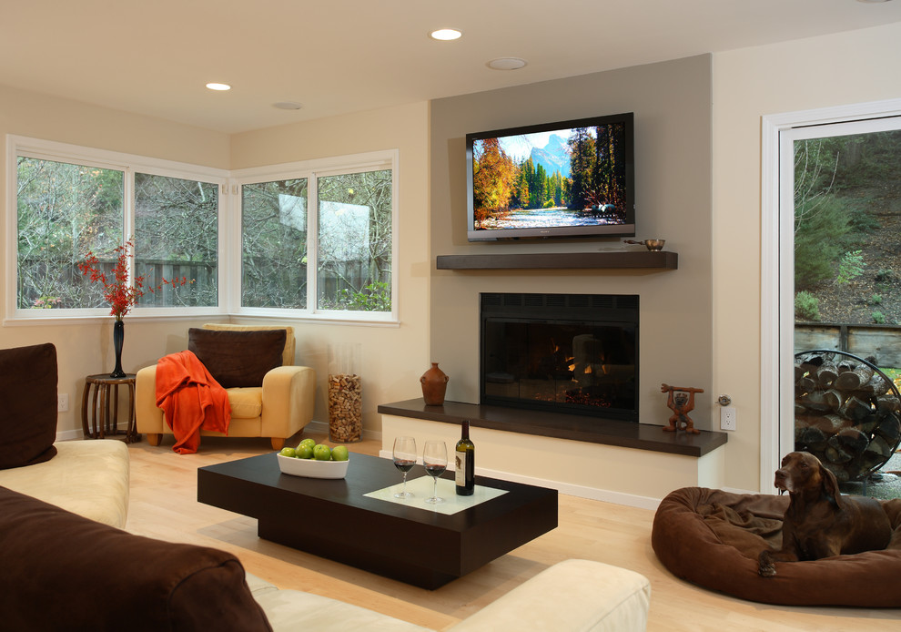 Design ideas for a mid-sized contemporary formal open concept living room in San Francisco with beige walls, light hardwood floors, a standard fireplace, a concrete fireplace surround and a wall-mounted tv.