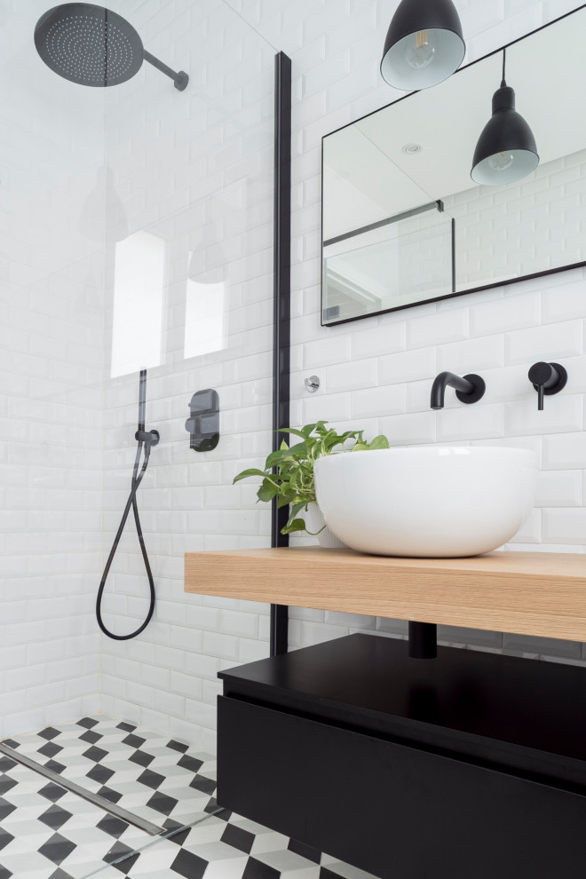 Contemporary bathroom in Cagliari with black cabinets, a curbless shower, a two-piece toilet, white tile, subway tile, white walls, cement tiles, a vessel sink, wood benchtops, multi-coloured floor, a hinged shower door, yellow benchtops, a niche and a double vanity.