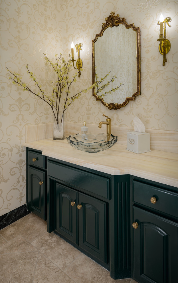This is an example of a large traditional 3/4 bathroom in Los Angeles with raised-panel cabinets, green cabinets, a two-piece toilet, beige tile, beige walls, travertine floors, a vessel sink, marble benchtops and beige floor.