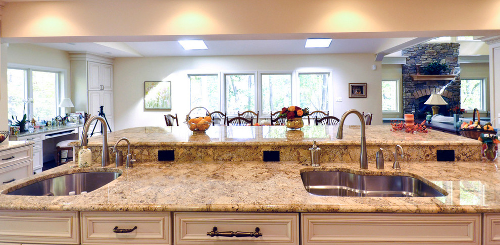 Kitchen photo in DC Metro with a single-bowl sink, recessed-panel cabinets, white cabinets, granite countertops, stainless steel appliances and an island