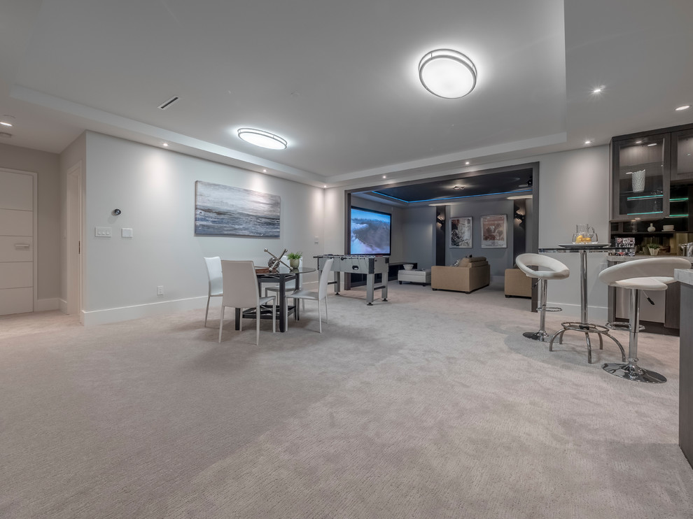 This is an example of a large contemporary basement in Vancouver with grey walls, carpet, no fireplace and grey floor.