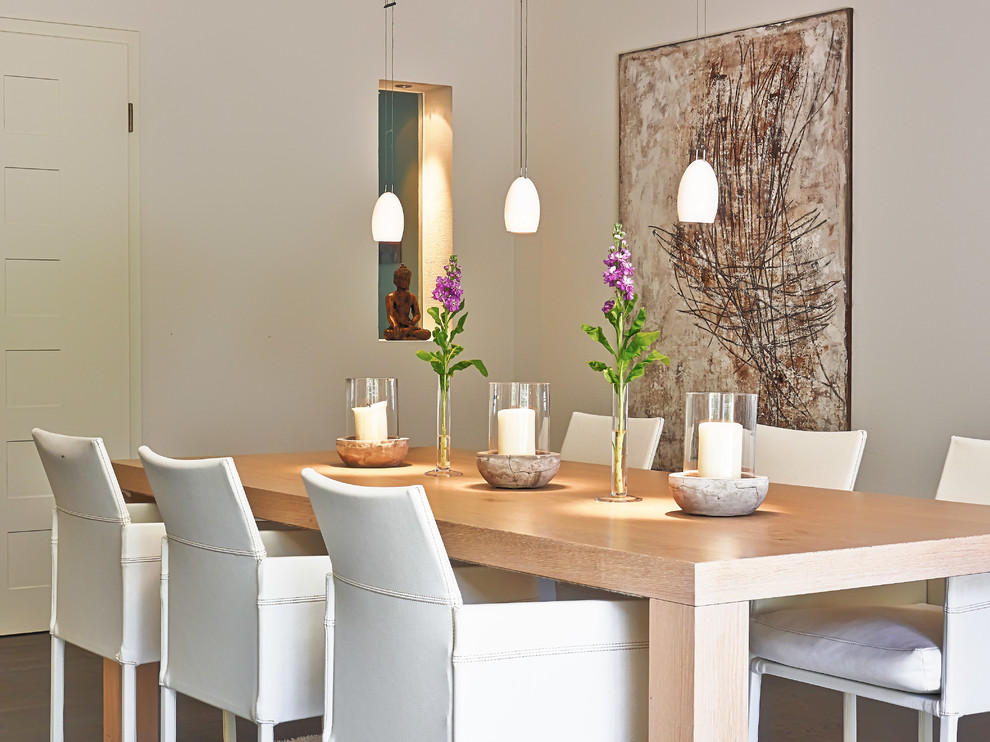 Contemporary dining room in Bonn with beige walls.