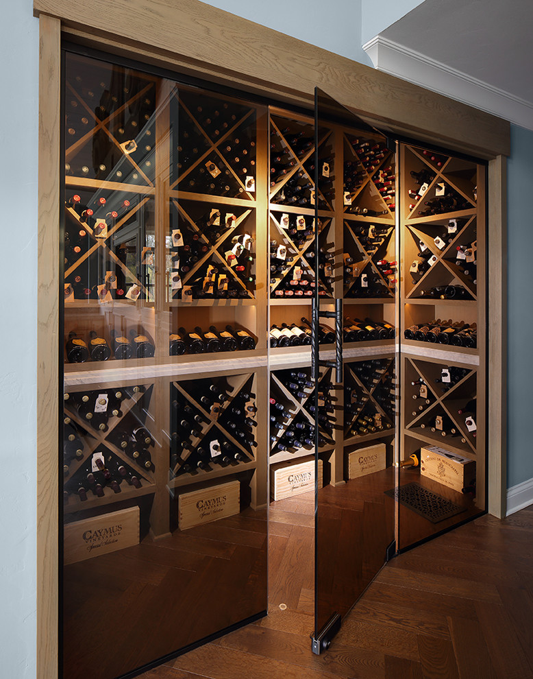 Design ideas for a country wine cellar in Milwaukee with medium hardwood floors, diamond bins and brown floor.
