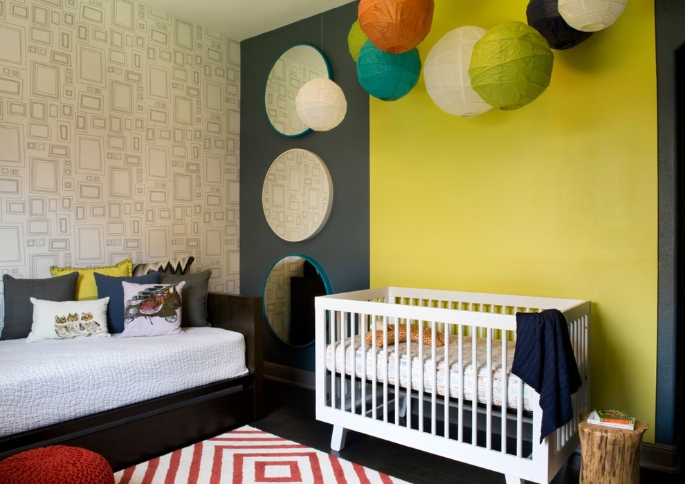 Mid-sized contemporary gender-neutral nursery in Austin with multi-coloured walls and dark hardwood floors.