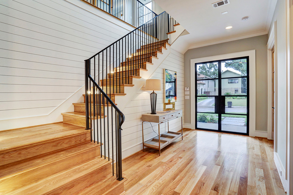 Mid-sized country wood l-shaped staircase in Houston with wood risers and metal railing.