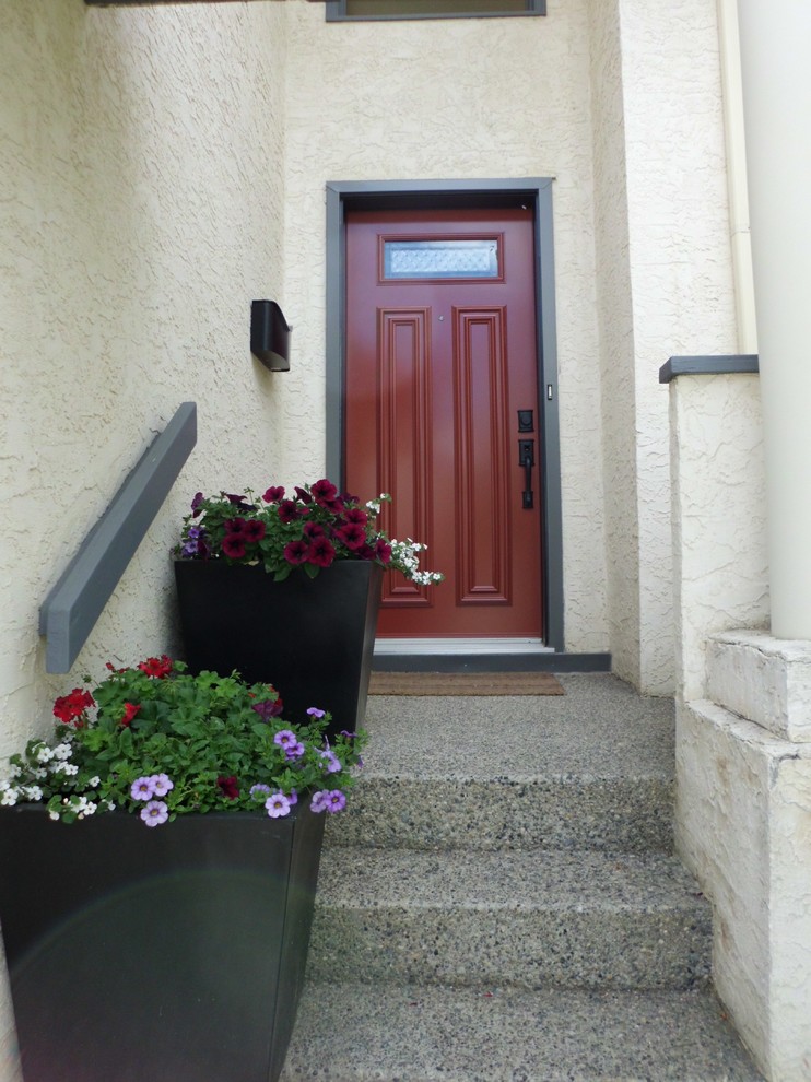 Large traditional front door in Calgary with white walls, a single front door and a red front door.