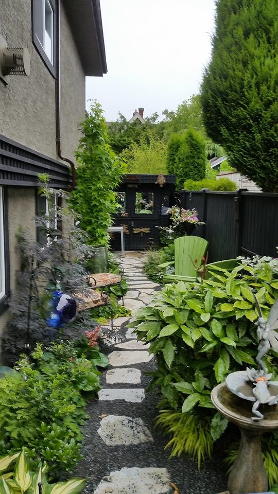 Inspiration for a small rustic partial sun side yard stone garden path.