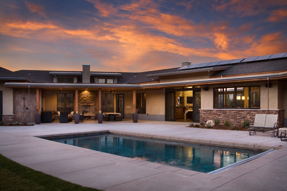 Photo of a large contemporary backyard rectangular lap pool in Other with concrete pavers.