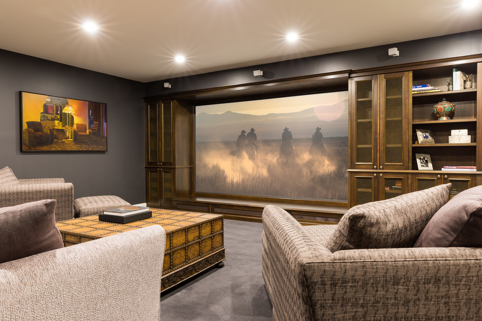 Large eclectic enclosed home theatre in Melbourne with grey walls, carpet and a projector screen.