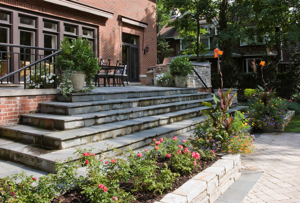 Photo of a backyard garden in Chicago with natural stone pavers.