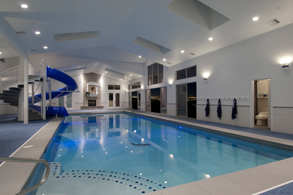 Inspiration for a contemporary indoor pool in Denver with a water slide.