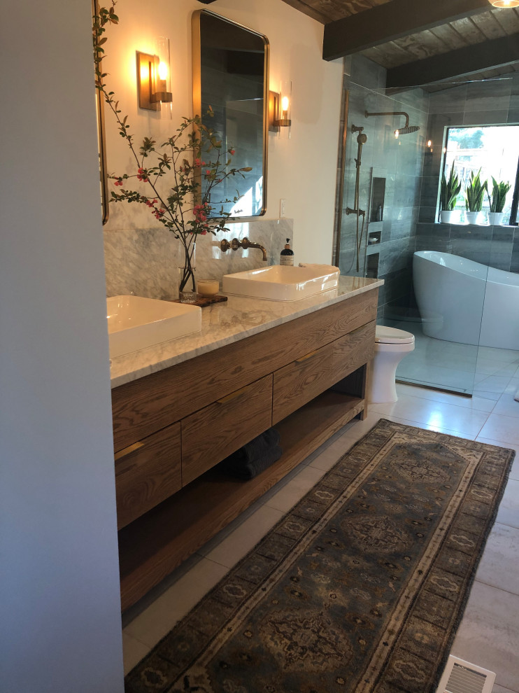Large midcentury master wet room bathroom in Seattle with light wood cabinets, a freestanding tub, gray tile, marble, white walls, ceramic floors, marble benchtops, grey floor, an open shower, white benchtops, a double vanity, a built-in vanity and exposed beam.