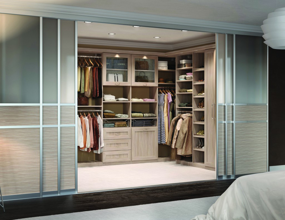 This is an example of a large contemporary gender-neutral walk-in wardrobe in Los Angeles with shaker cabinets and light wood cabinets.