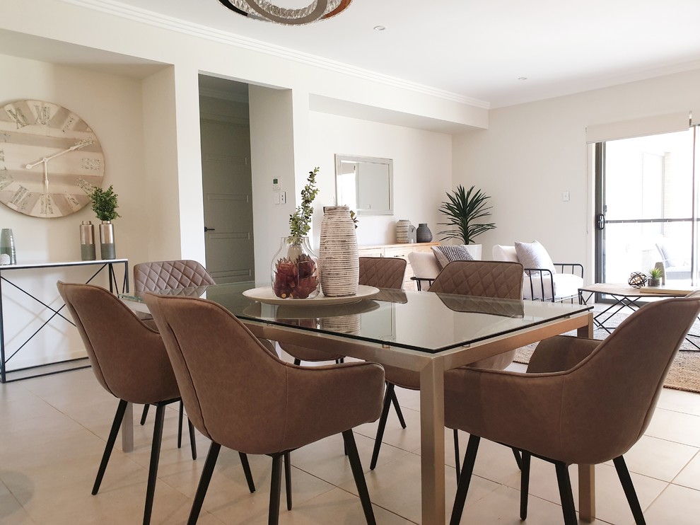 This is an example of a contemporary open plan dining in Sydney with white walls, ceramic floors and beige floor.