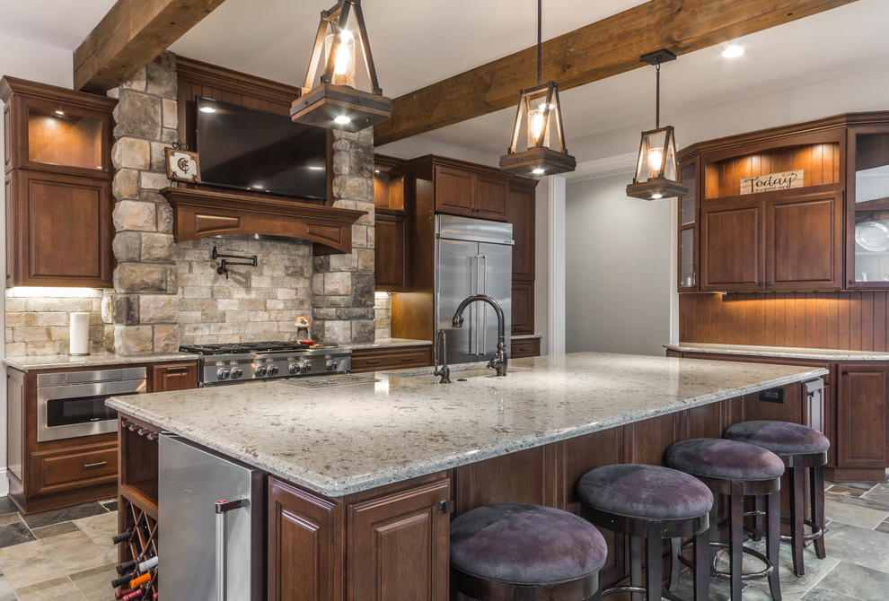 Inspiration for an expansive country l-shaped eat-in kitchen in Detroit with an undermount sink, raised-panel cabinets, medium wood cabinets, quartz benchtops, beige splashback, stone tile splashback, stainless steel appliances, slate floors, with island and green floor.
