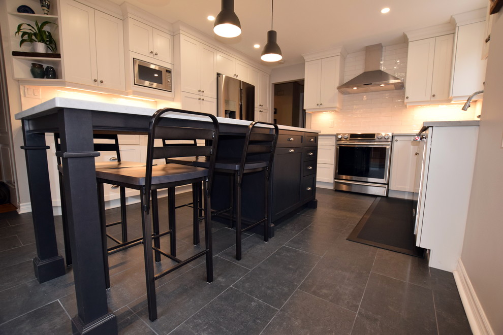 Example of a mid-sized transitional l-shaped ceramic tile enclosed kitchen design in Ottawa with an undermount sink, shaker cabinets, white cabinets, quartz countertops, white backsplash, subway tile backsplash, stainless steel appliances and an island