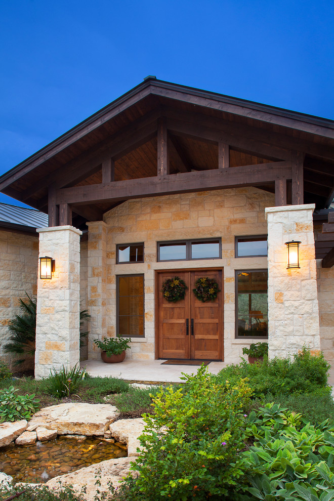 Inspiration for a country exterior in Austin with stone veneer.