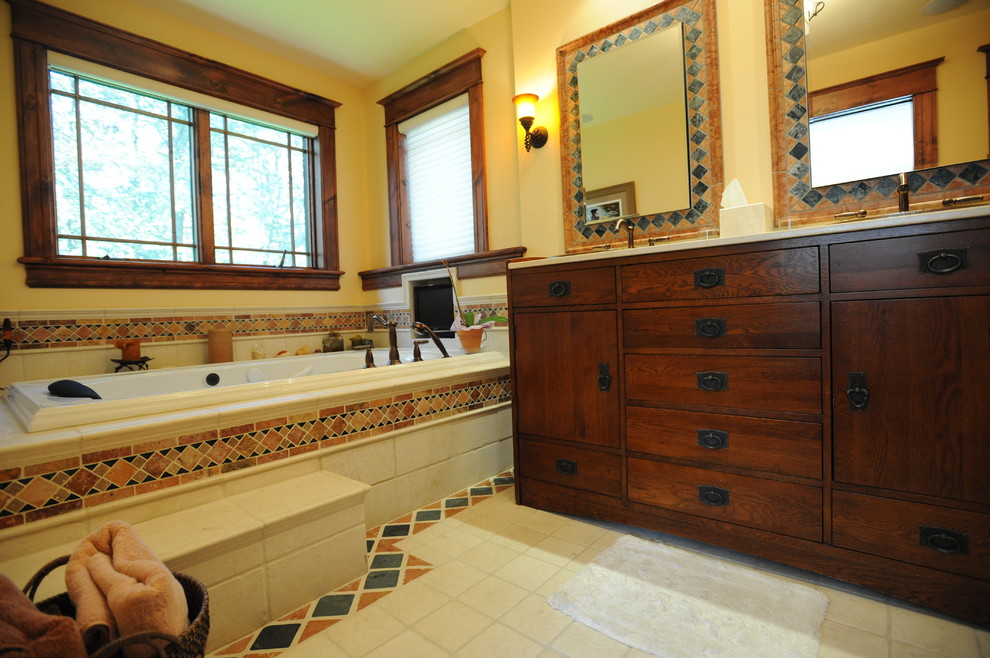Photo of a country master bathroom in New York with a drop-in sink, medium wood cabinets, a drop-in tub, an alcove shower, white tile, ceramic tile, beige walls and ceramic floors.