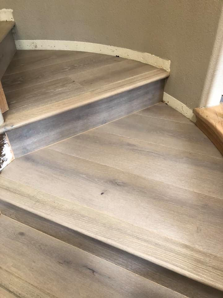 Photo of a mid-sized beach style wood l-shaped staircase in San Diego with wood risers and wood railing.