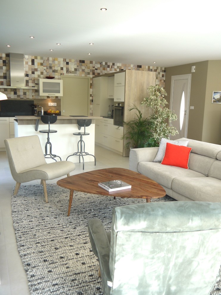 Photo of a mid-sized scandinavian open concept living room in Angers with green walls, ceramic floors, no fireplace, grey floor and a freestanding tv.