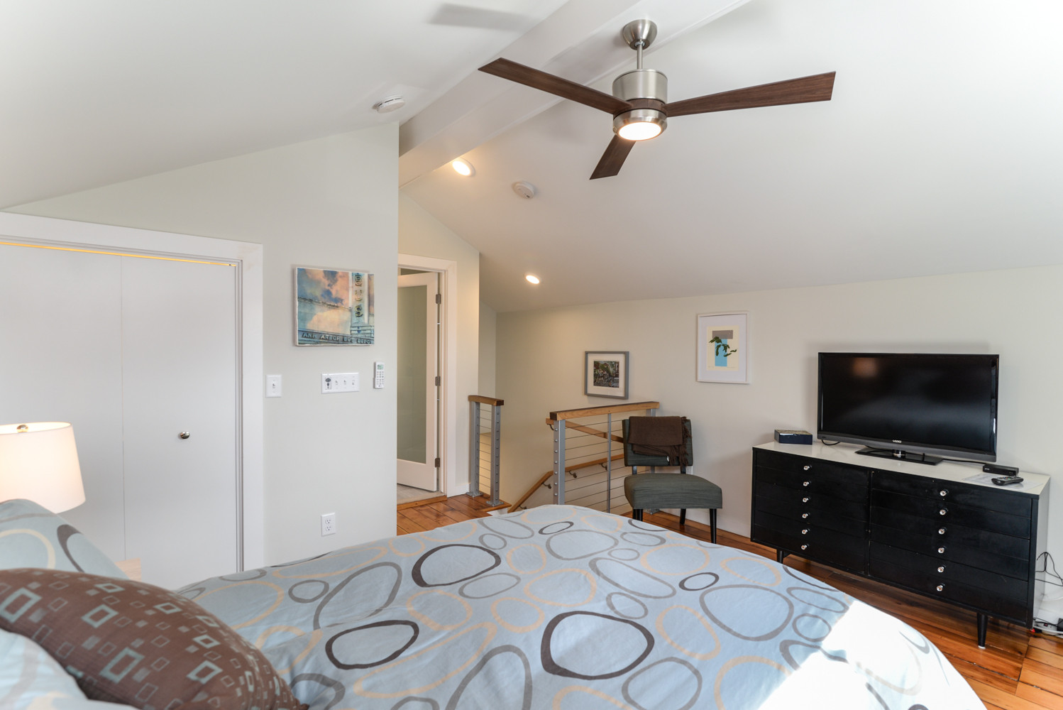 The staircase leads directly to the master bedroom area, with an attached bathroom shown in the background. Although smaller in scale, the overall feel is open and airy with plenty of storage in the u