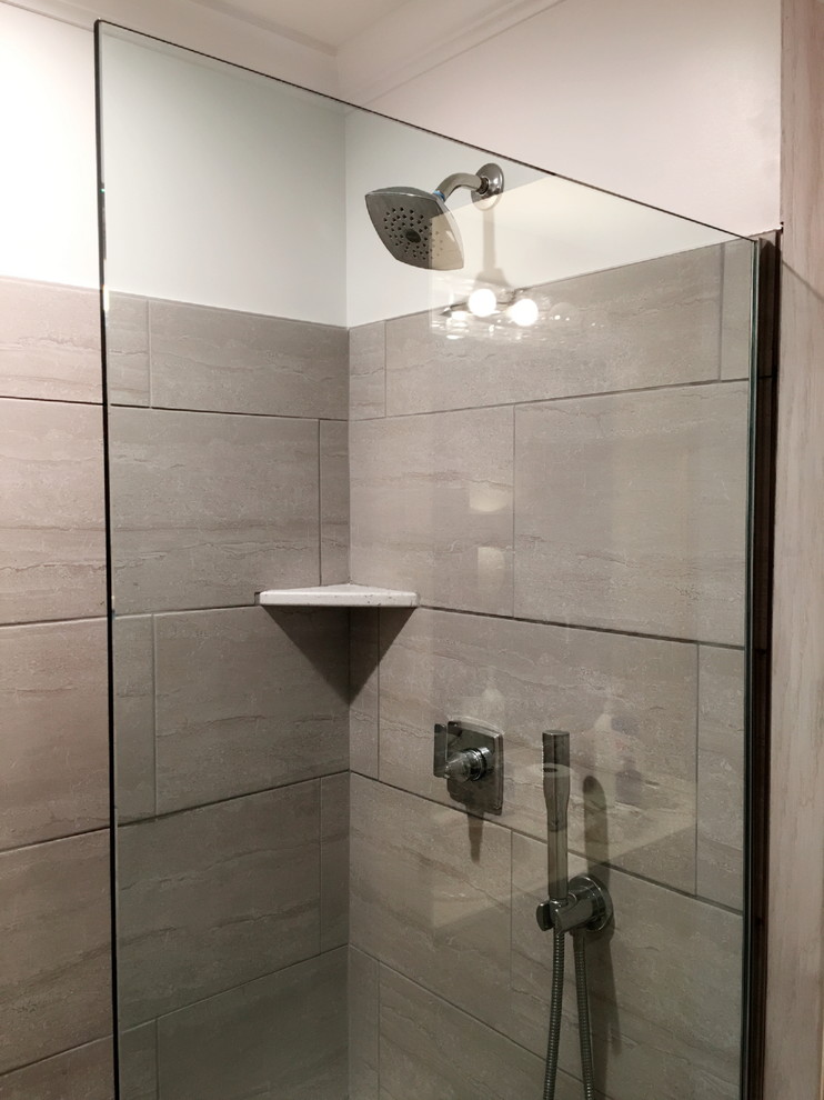 Example of a mid-sized transitional beige tile, brown tile and porcelain tile porcelain tile and beige floor alcove shower design in Detroit with a two-piece toilet and beige walls