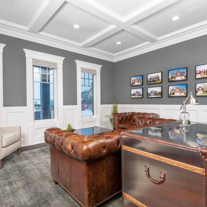 Traditional home office in Edmonton with grey walls, dark hardwood floors, a freestanding desk, brown floor, coffered and decorative wall panelling.