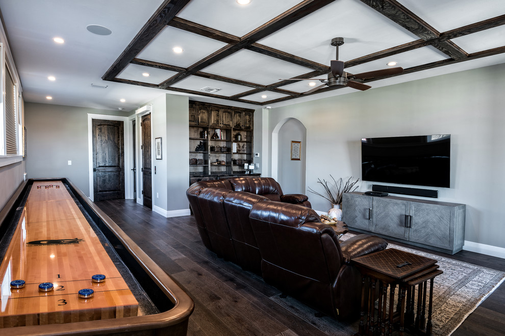 This is an example of a large transitional enclosed family room in Austin with a game room, grey walls, dark hardwood floors, no fireplace, a wall-mounted tv and brown floor.