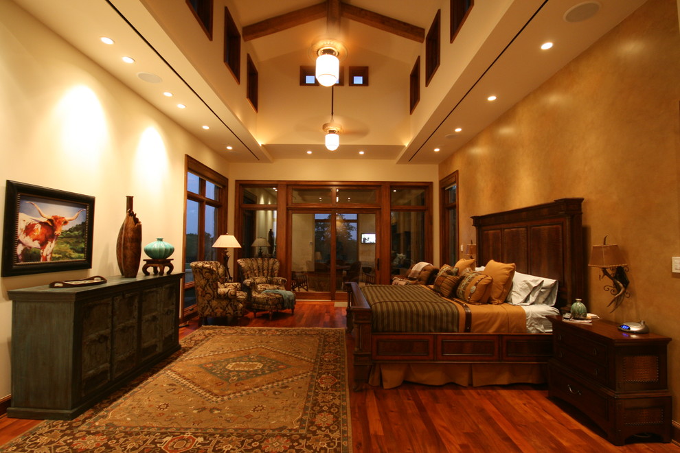 Photo of an eclectic bedroom in Dallas with beige walls and dark hardwood floors.