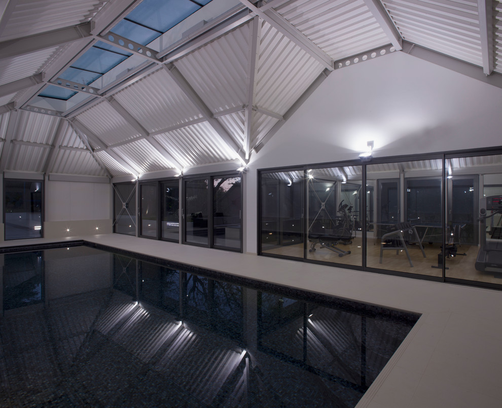 Inspiration for a mid-sized contemporary multipurpose gym in London with white walls, ceramic floors and white floor.