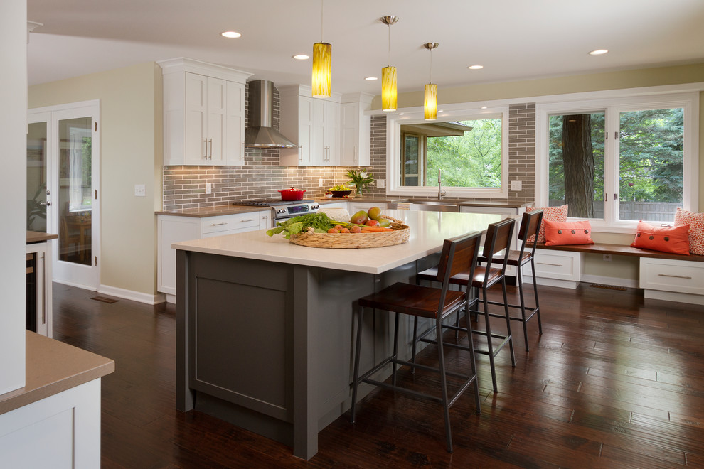Photo of a large traditional l-shaped kitchen in Minneapolis with white cabinets, dark hardwood floors and with island.