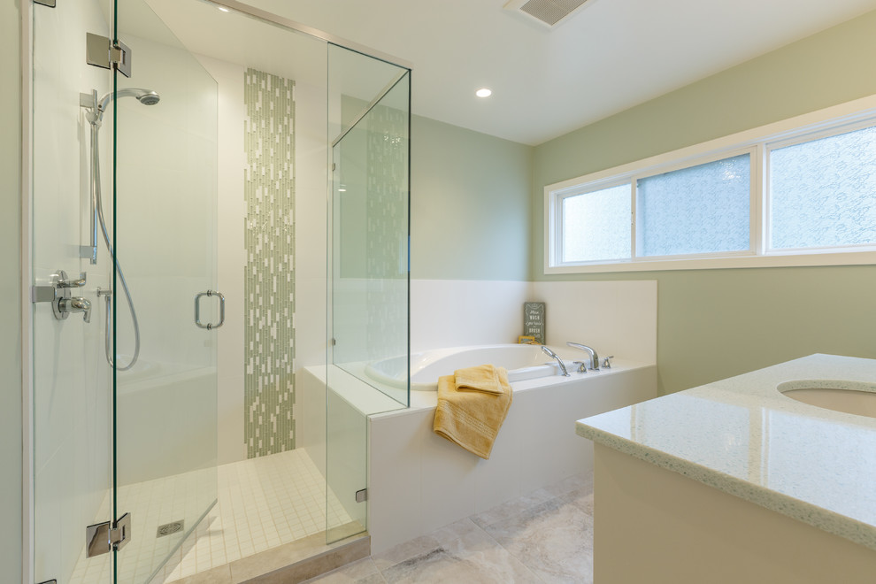 This is an example of a mid-sized contemporary master bathroom in Vancouver with an undermount sink, shaker cabinets, white cabinets, recycled glass benchtops, a drop-in tub, a corner shower, a two-piece toilet, gray tile, porcelain tile, green walls and porcelain floors.