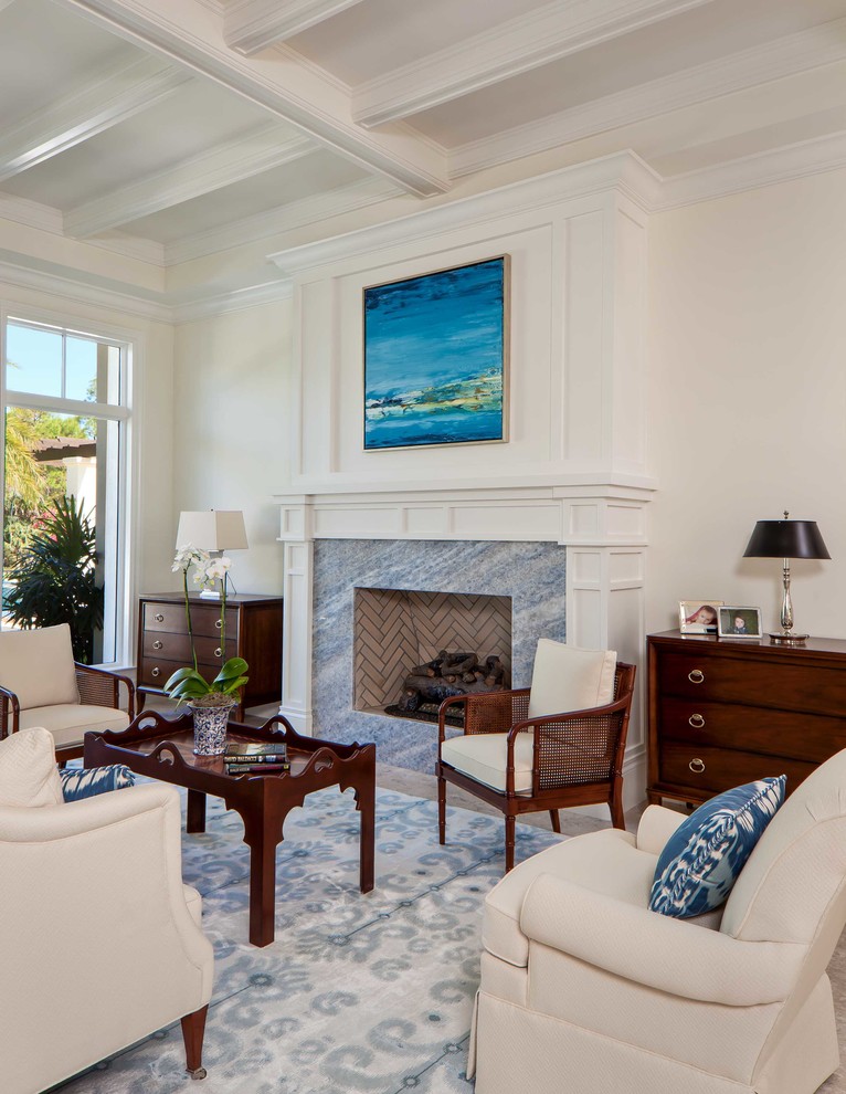 Tropical formal living room in Miami with white walls, a stone fireplace surround and no tv.
