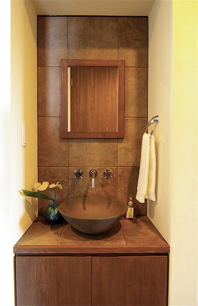 Midcentury powder room in Other with brown cabinets, brown tile, porcelain tile, white walls, medium hardwood floors, tile benchtops, brown floor and brown benchtops.