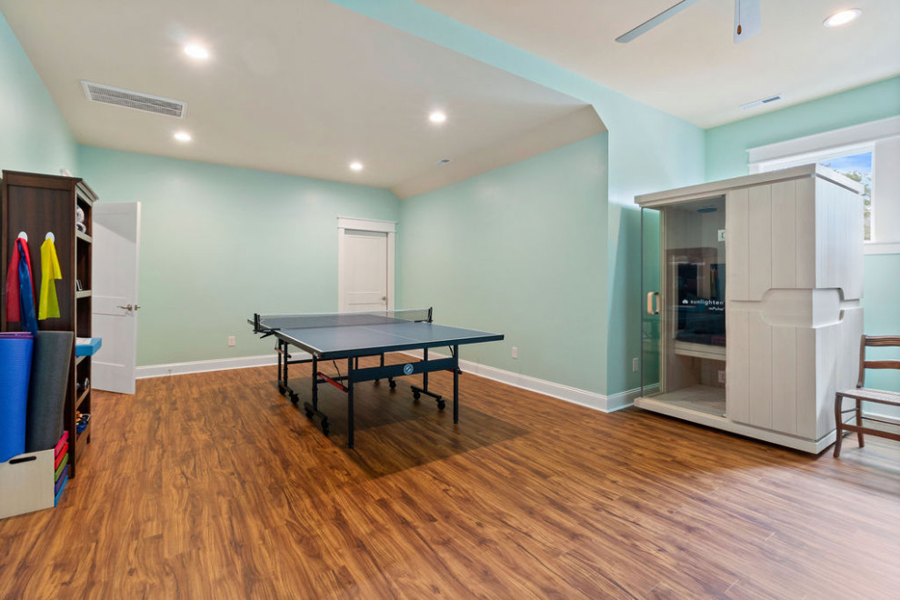 Photo of a large beach style multipurpose gym in Raleigh with green walls, vinyl floors and brown floor.